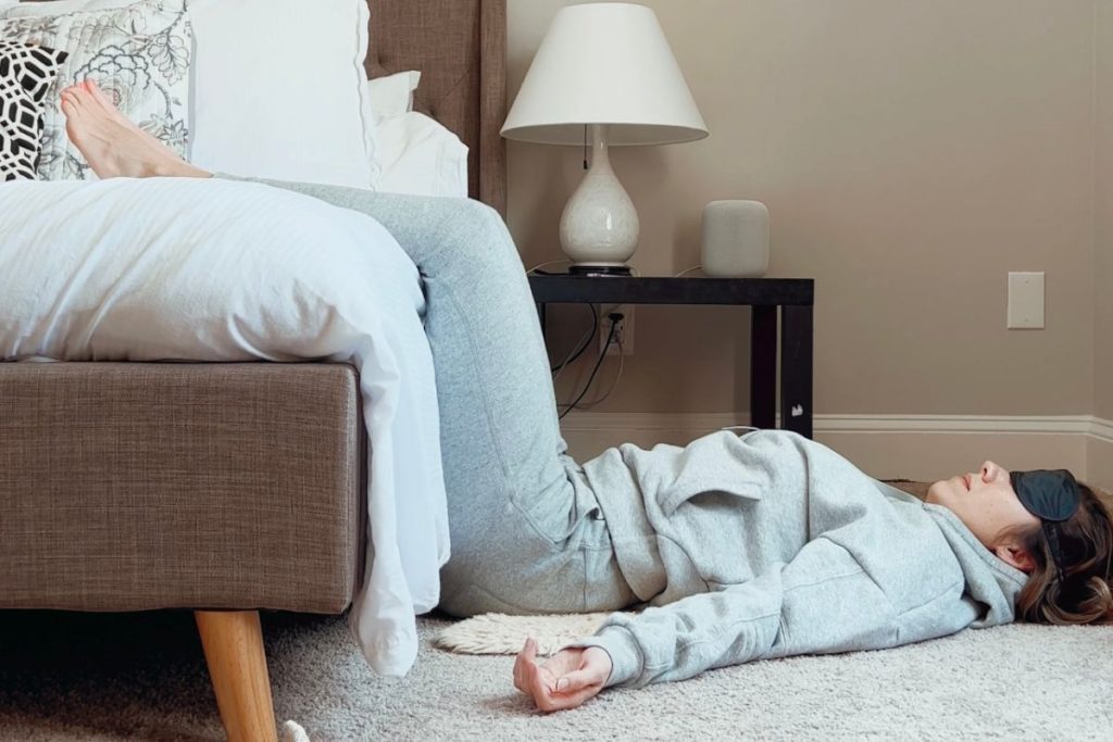 Jen Bell's yoga nidra setup with legs up, and eye pillow